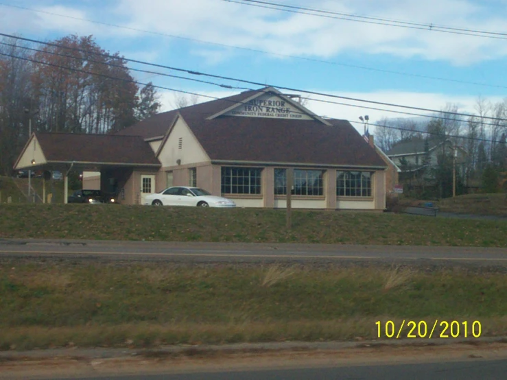 the car is parked outside the small business