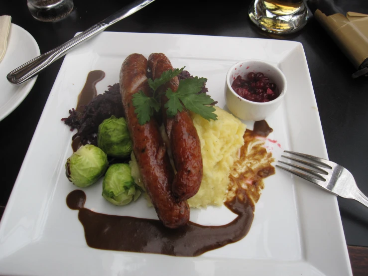 a plate of food with two long  dogs