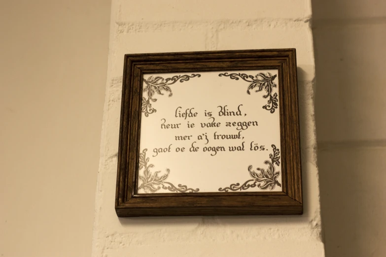 a frame with a verse above it hanging on a wall