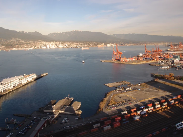 the view looking down on the city of vancouver, with a train crossing in the foreground