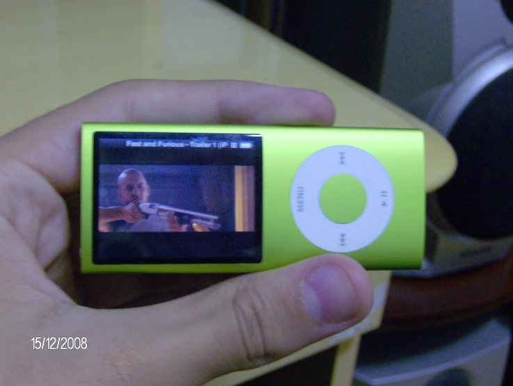 there is a person holding a green mp3 player