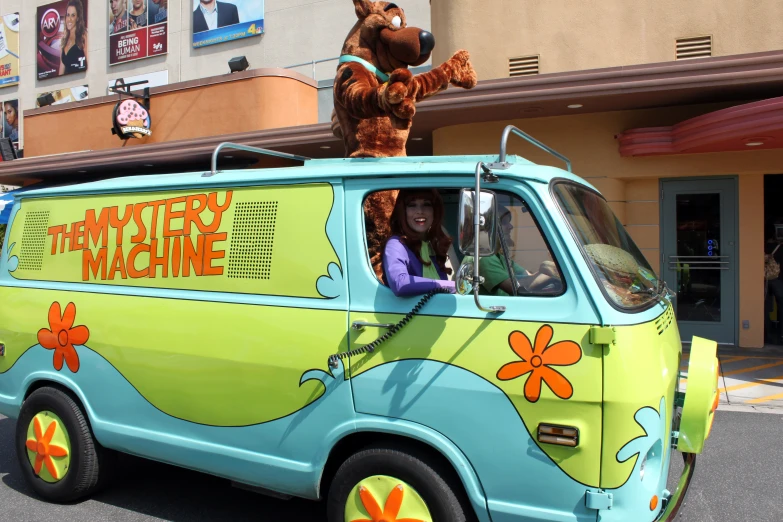 a scooby the cat van driving down the street