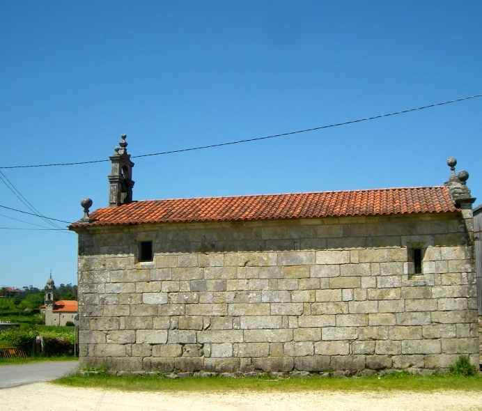 a building made from stone bricks with red tiles