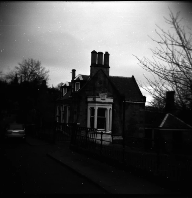 a black and white image of an old brick house