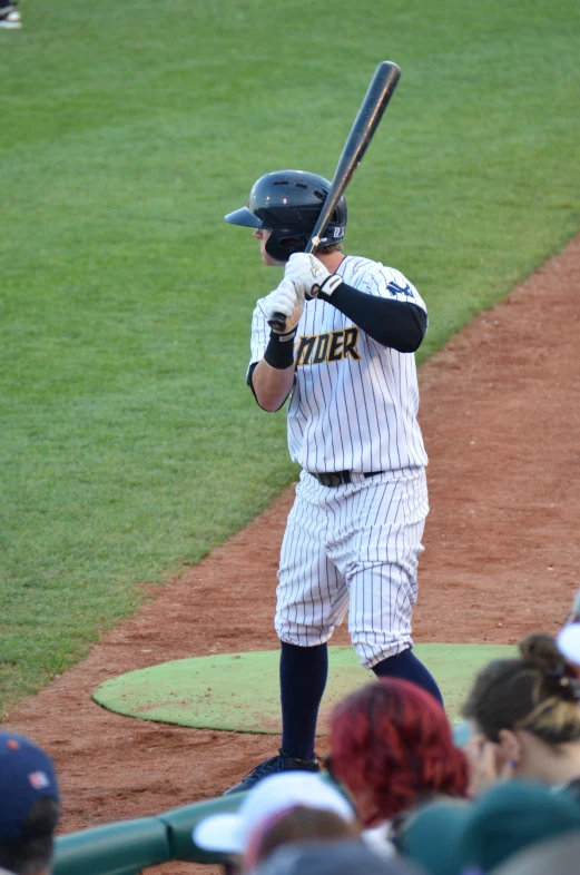 the player holding the bat waits for the ball to come