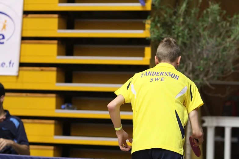 two men in matching yellow jerseys standing next to each other