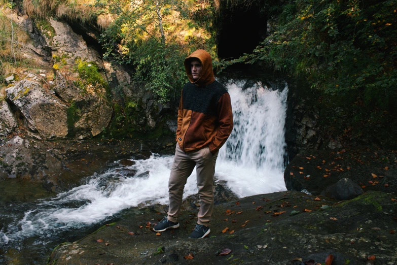 man standing in front of waterfall, possibly in europe