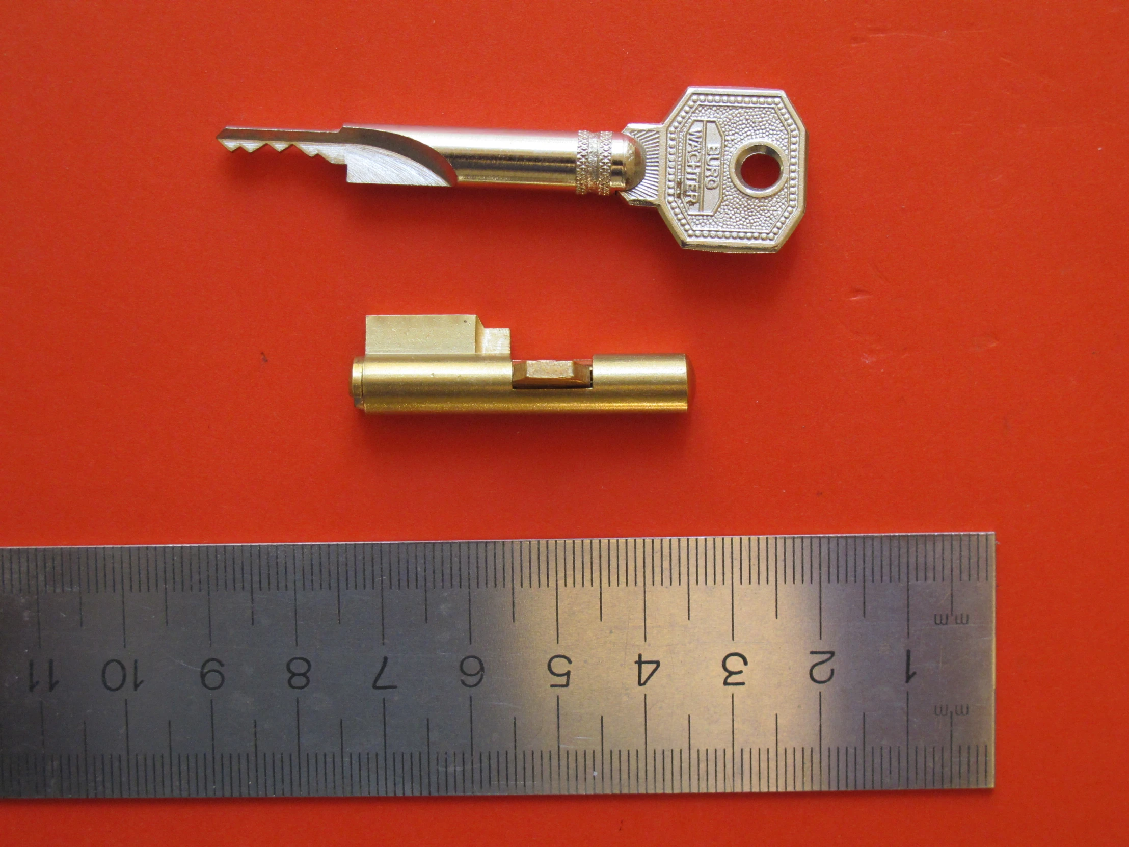 two different size ss and metal tools next to a ruler