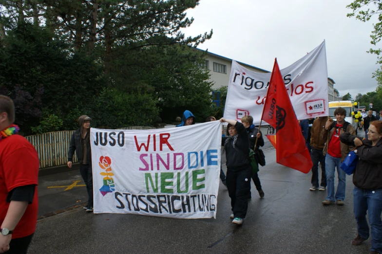 protesters march on the street holding signs and banners