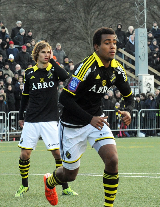 two soccer players are in the field playing