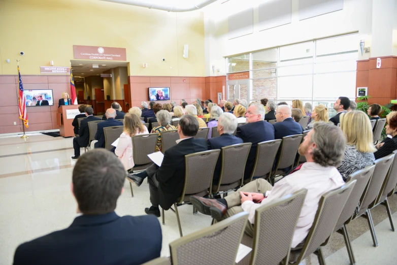 a large group of people that are sitting in chairs