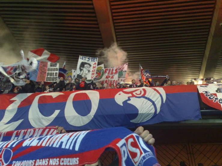 fans holding up a huge red and blue banner