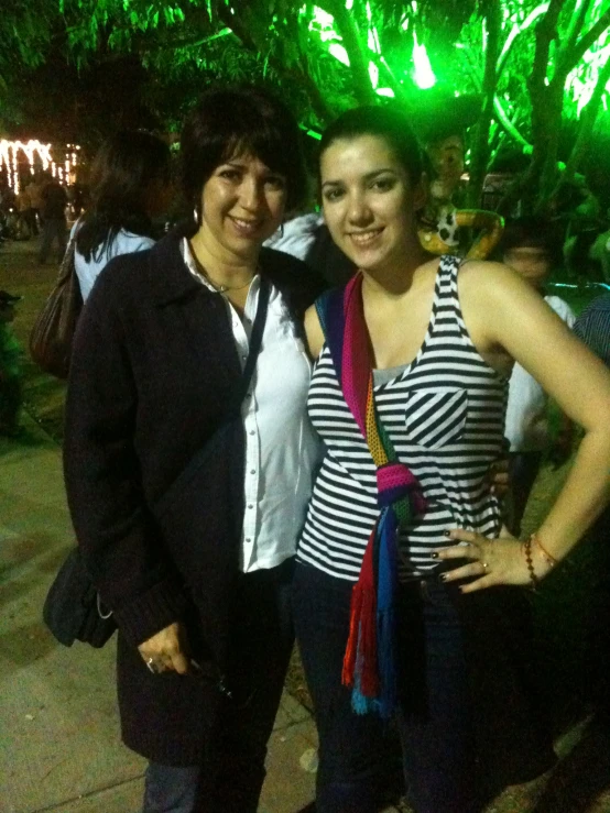 two girls standing together at a party