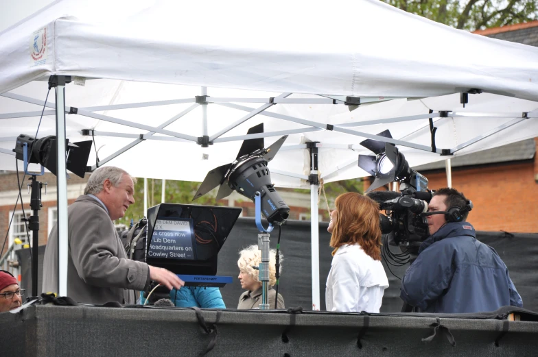 a cameraman and two people are filming