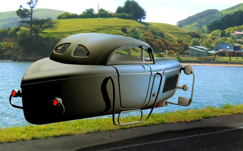 a car parked next to the ocean and some grass