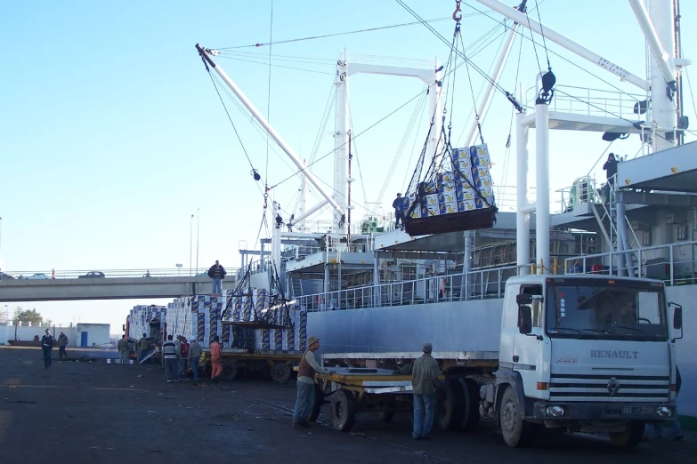 an airplane being lifted off the truck by crane