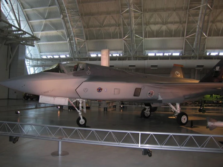 a fighter jet sits on display in an aircraft museum