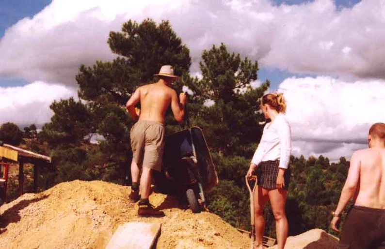 several people are climbing up a hill near a ski lift