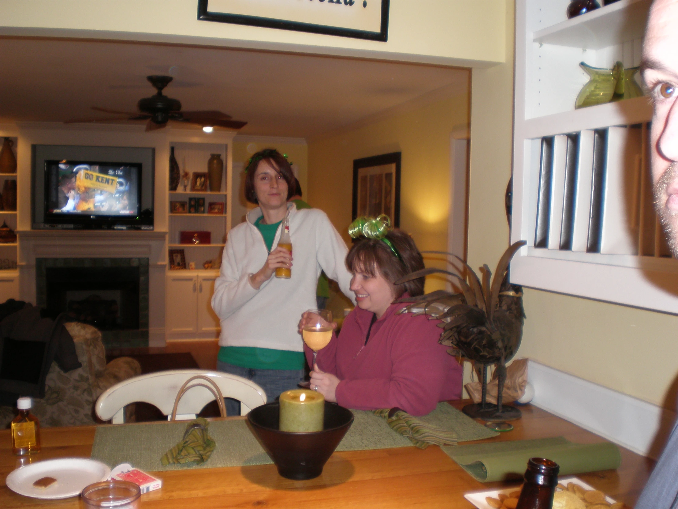 two people in a living room drinking a drink