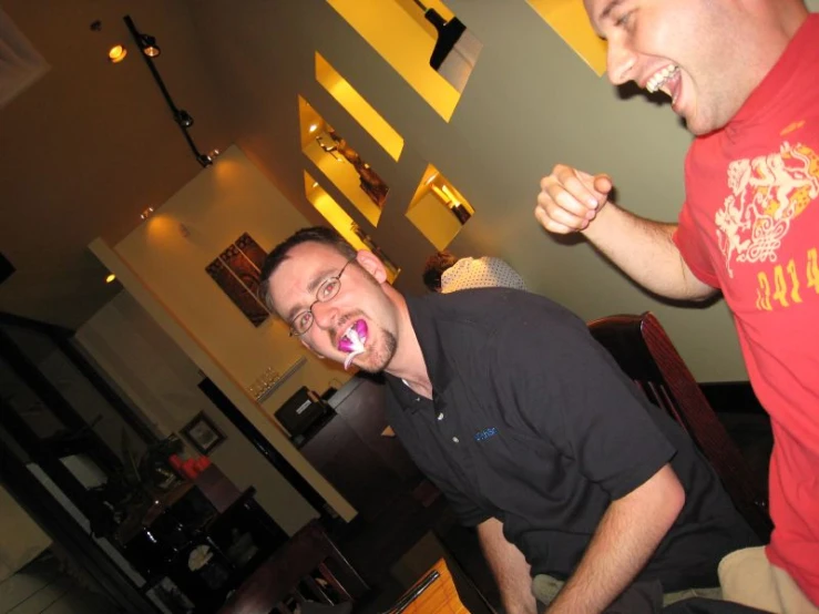 two men in a bar are laughing at each other