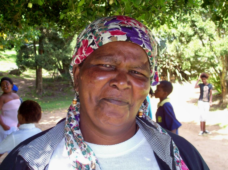 an older woman with several children in the background