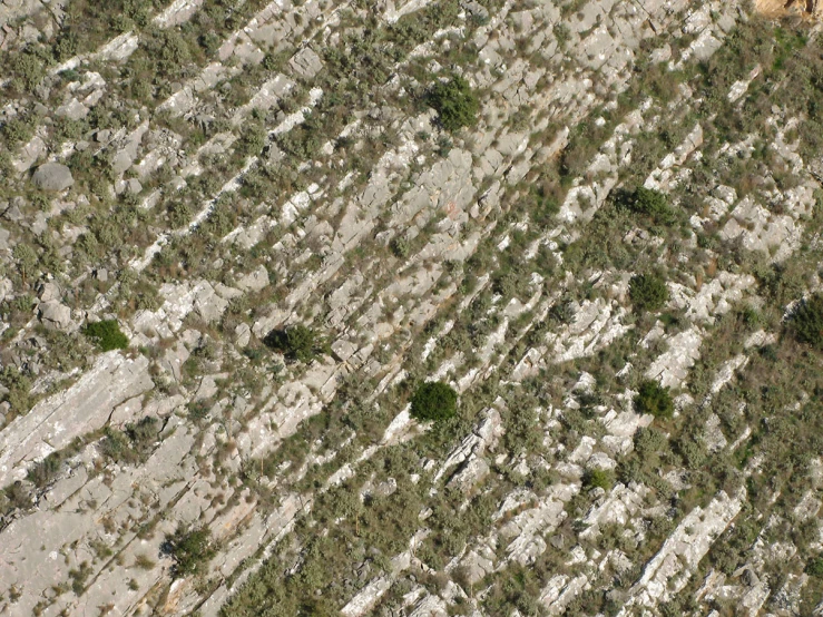 a aerial view of some rocky hills and grass