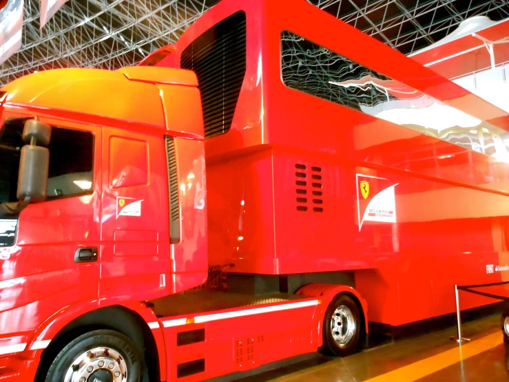 large bright red truck parked inside an indoor warehouse