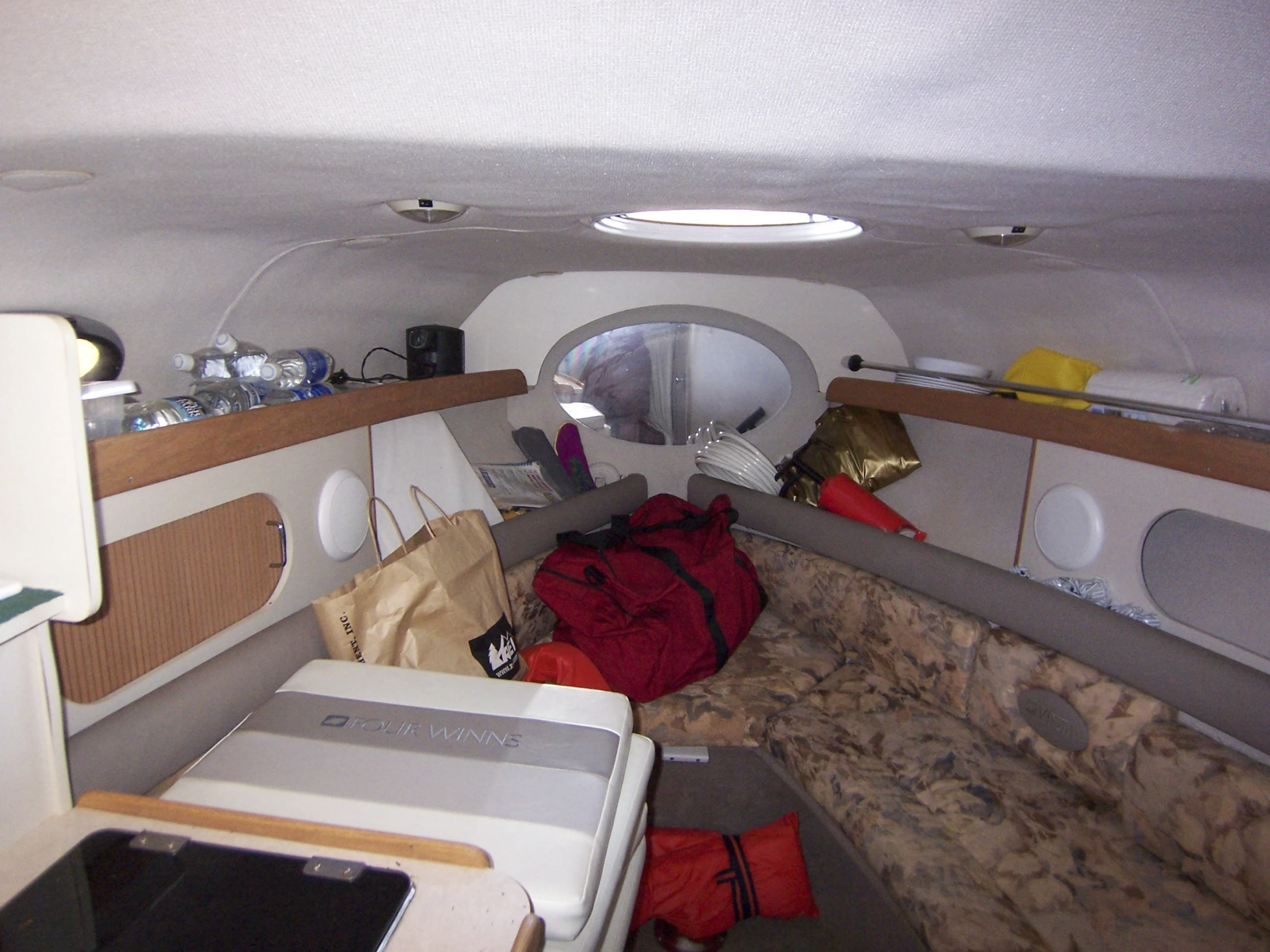 inside a room in an airplane with bags and other objects