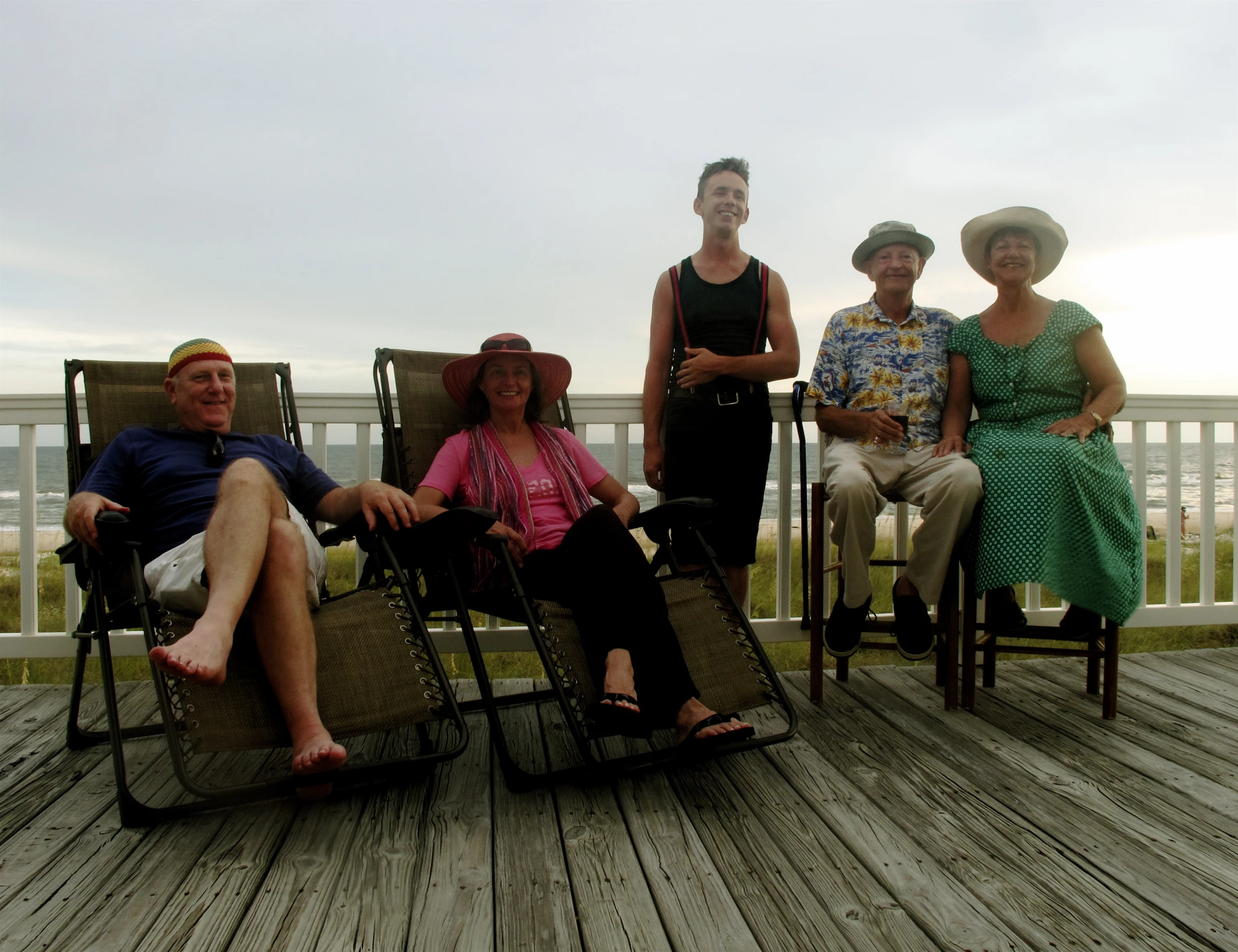 five people pose for a picture on the porch