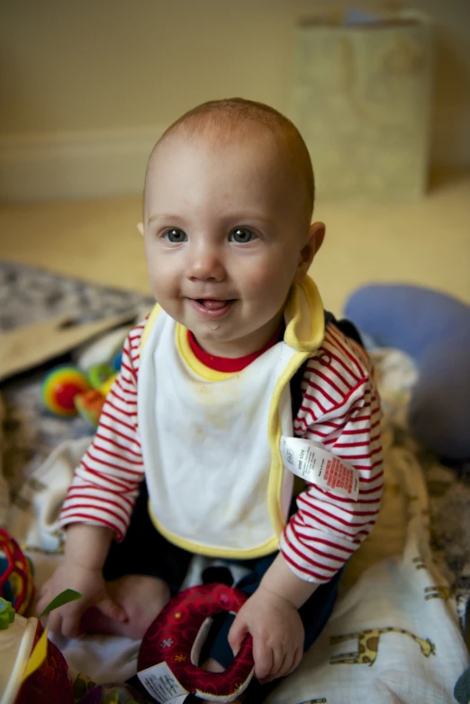 there is a young child wearing a red and white striped shirt