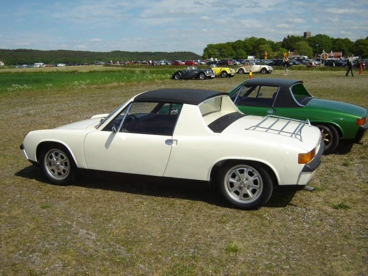 two cars parked in a field next to each other