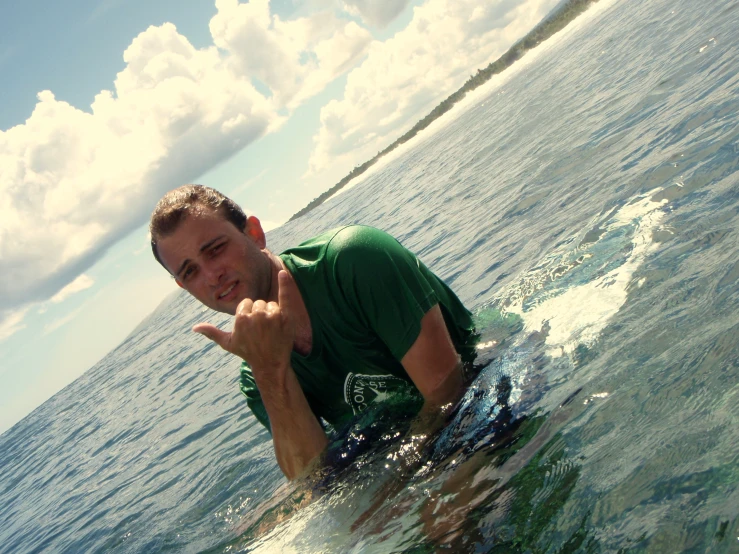 a man with a surfboard poses in the water