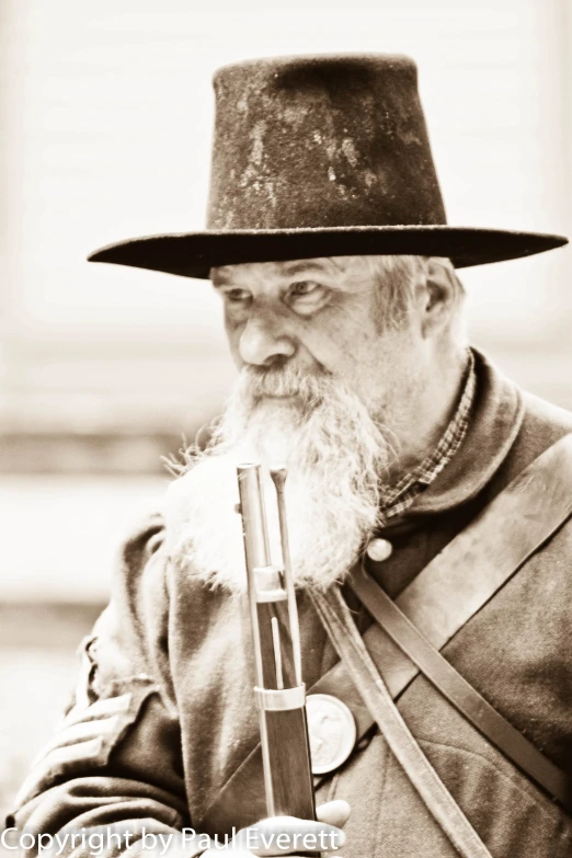 a man with a large long beard and a small sword in his hand