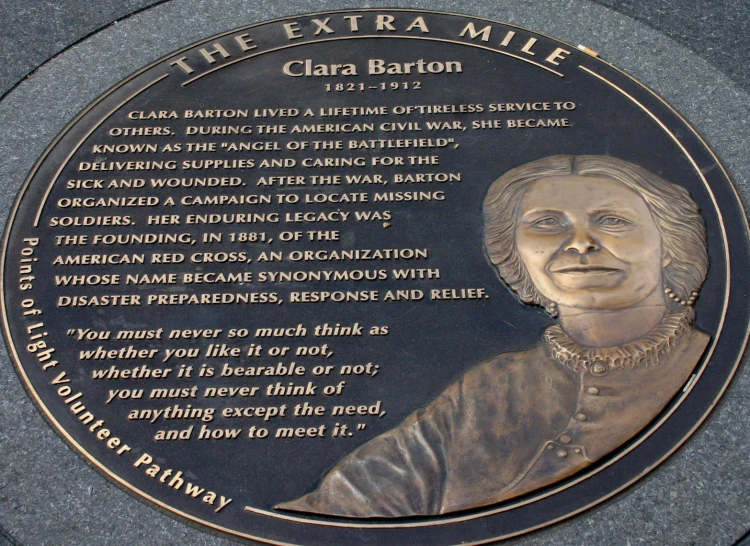 a plaque written on top of a grey concrete wall