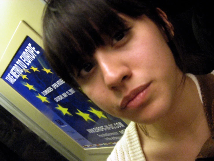 a young woman in an elevator posing for the camera