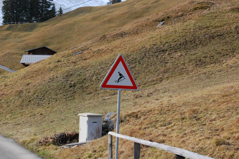 a yield sign at the top of a mountain