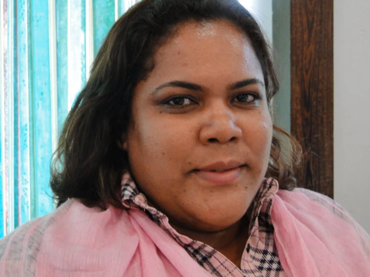 a woman with a pink scarf on her neck