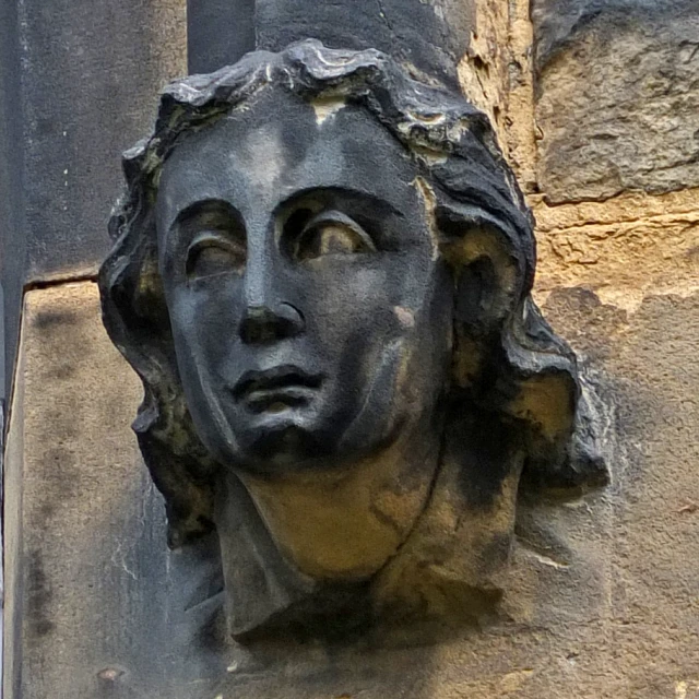 a close up of a face on a wall