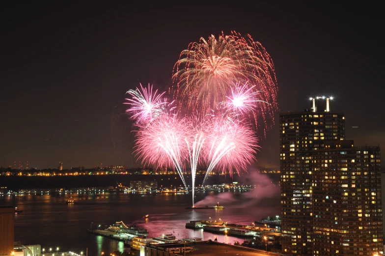 large fireworks exploding in the sky above city lights