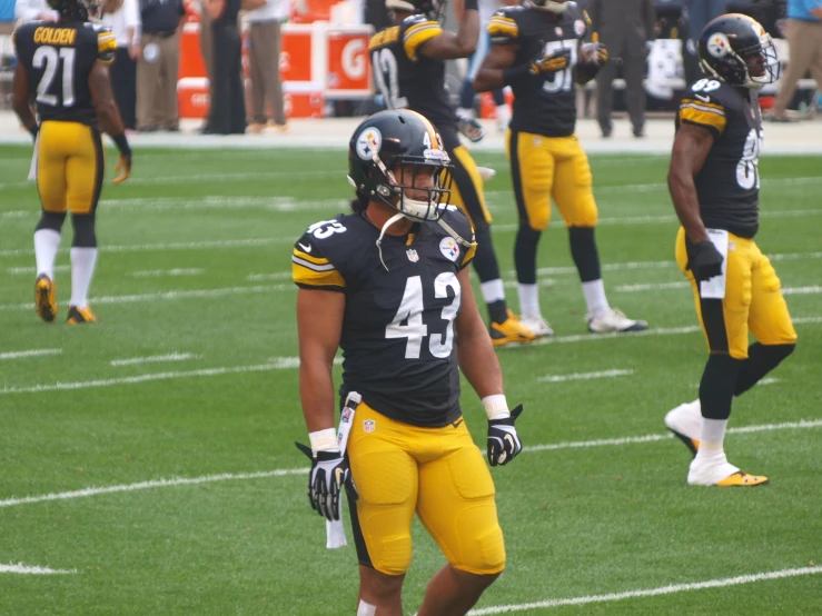 a football team walking onto the field during a game