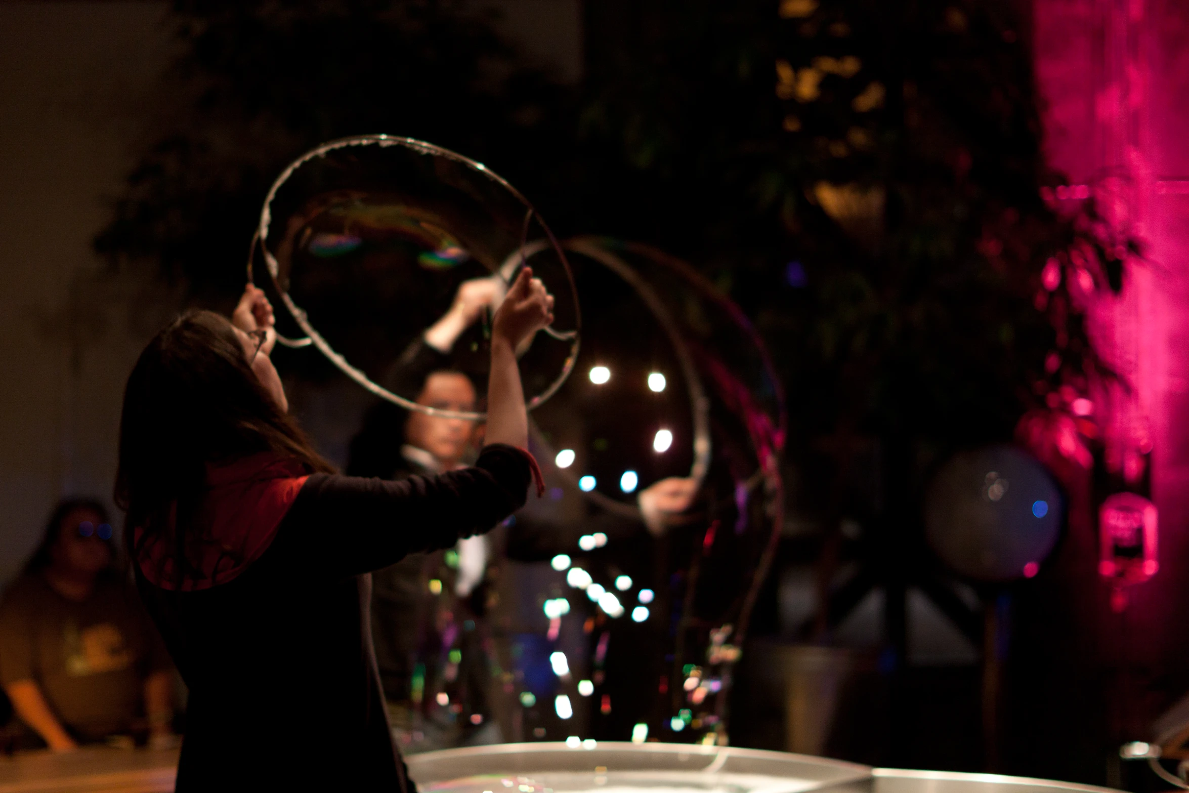 two people are playing with a ring and some lights