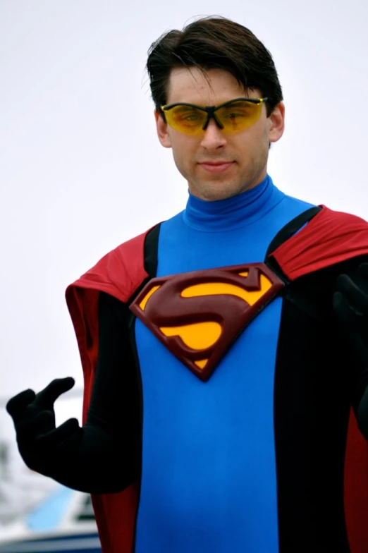 a man dressed up as a superman on top of a field