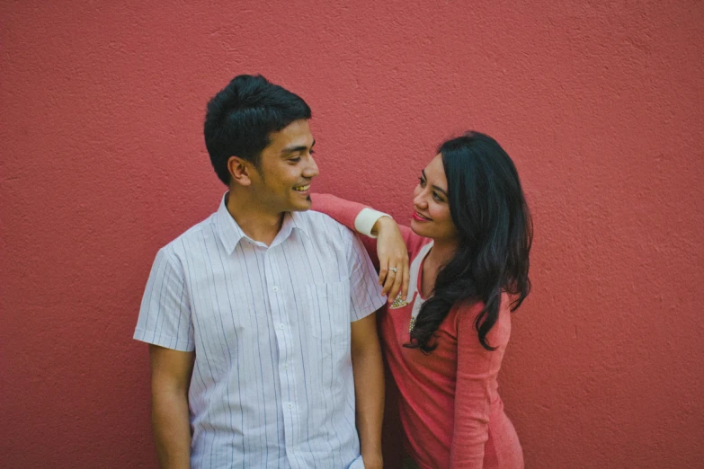 a young man and woman are smiling for the camera