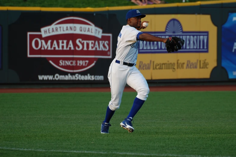 the man is in mid air catching a baseball