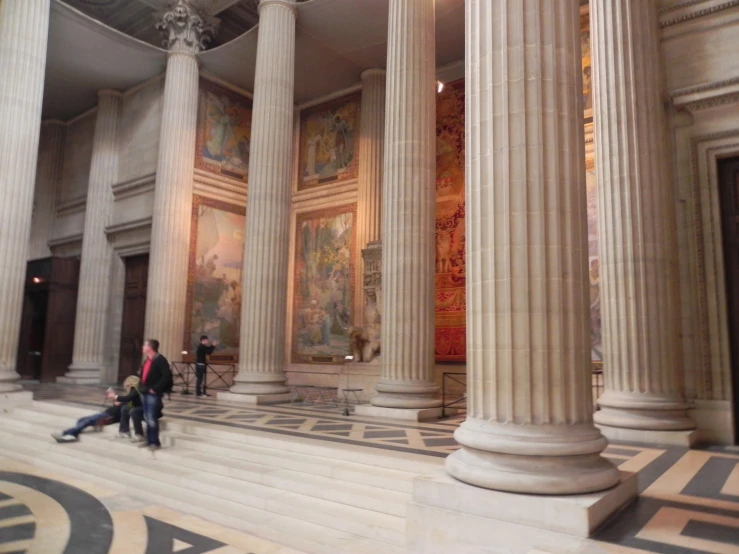 people are standing around inside an ornate building