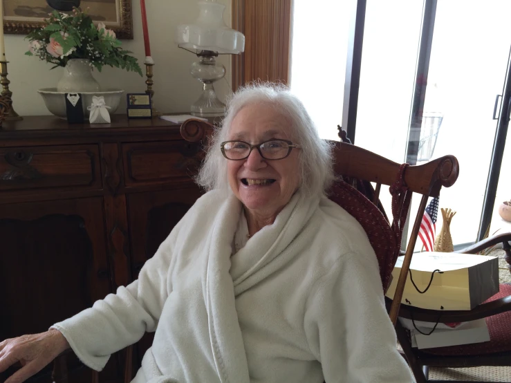 a woman in white shirt sitting in a chair