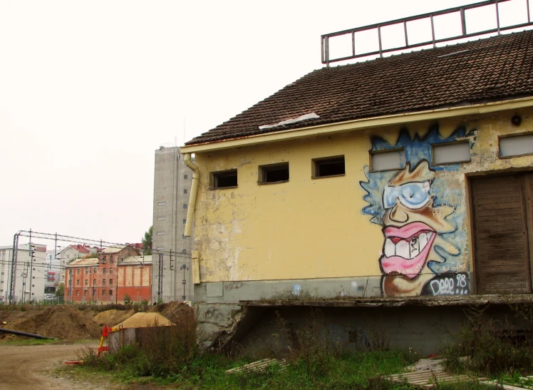 a building painted with graffiti and a door that has a person on the side