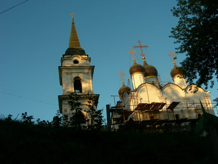 two church steeples at dawn seen from the surrounding trees