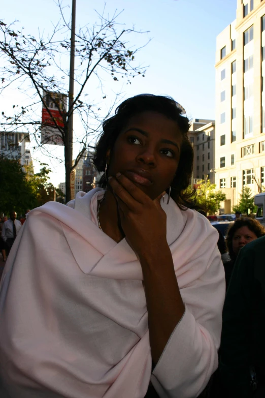 a woman wearing a pink top is looking up