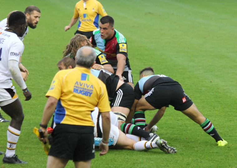 several rugby players are on the field playing